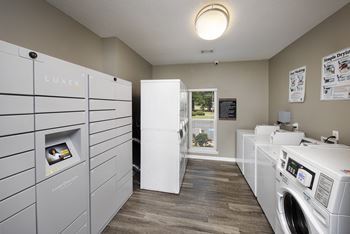 a laundry room with washer and dryers and a window